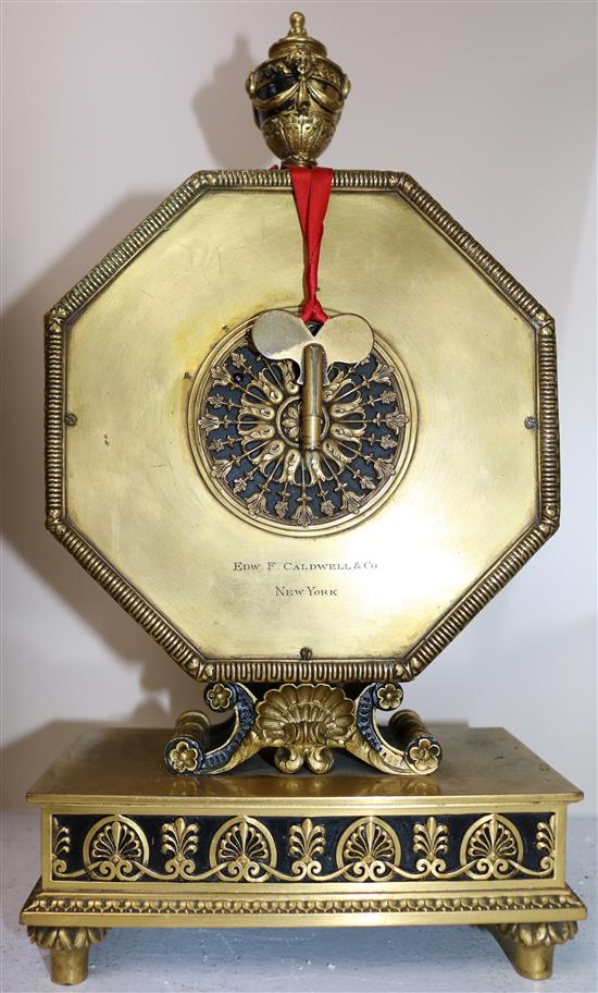 An early 20th century gilt and ebonised octagonal cased mantel clock retailed by Edward F. Caldwell & Co, New York, 13.75in.